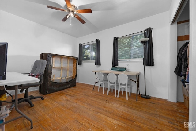 home office with wood-type flooring and ceiling fan