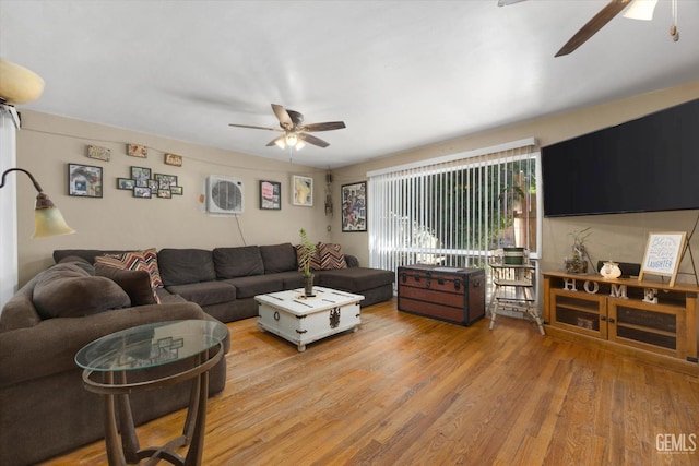 living room with ceiling fan and light wood-type flooring