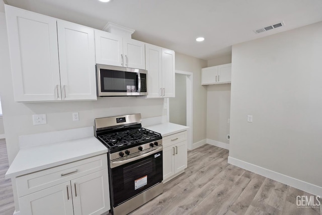 2408 Charleston Dr, Bakersfield, CA 93308 - kitchen with appliances with stainless steel finishes, light wood-style floors, recessed lighting, white cabinets, and light countertops
