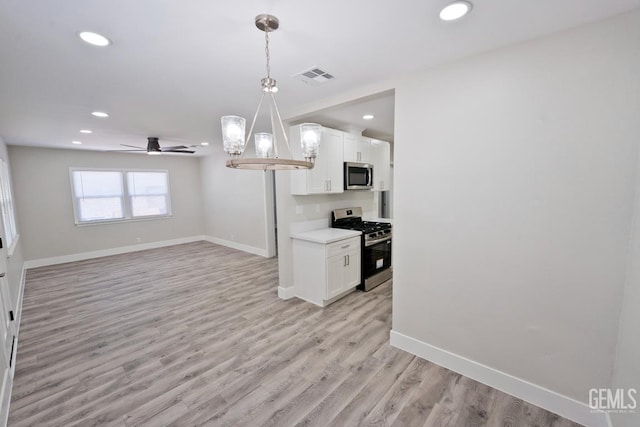 2408 Charleston Dr, Bakersfield, CA 93308 - kitchen with stainless steel appliances, a ceiling fan, white cabinetry, recessed lighting, and light wood-style flooring