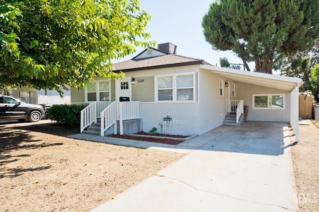 2408 Charleston Dr, Bakersfield, CA 93308 - view of front of property with concrete driveway, an attached carport, stucco siding, and a shingled roof