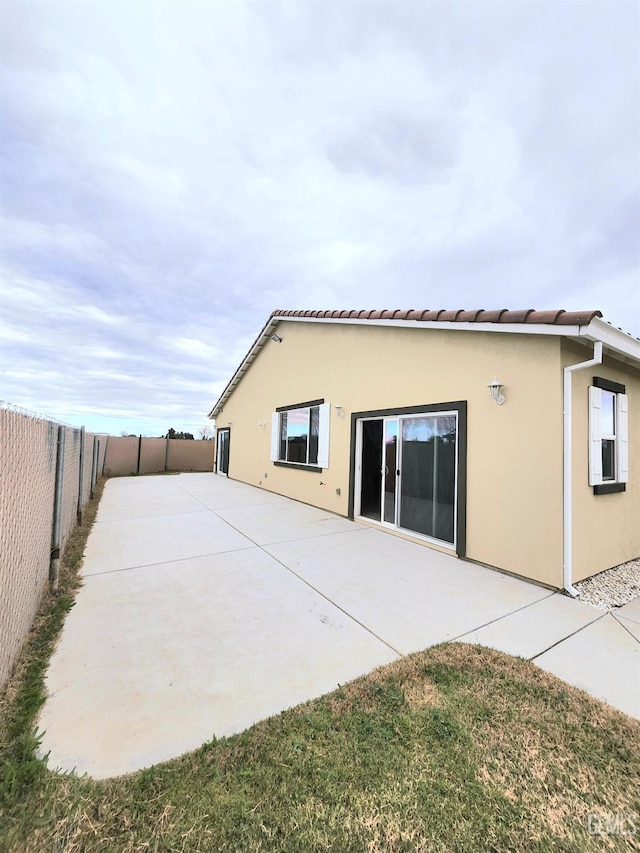 back of property with a patio