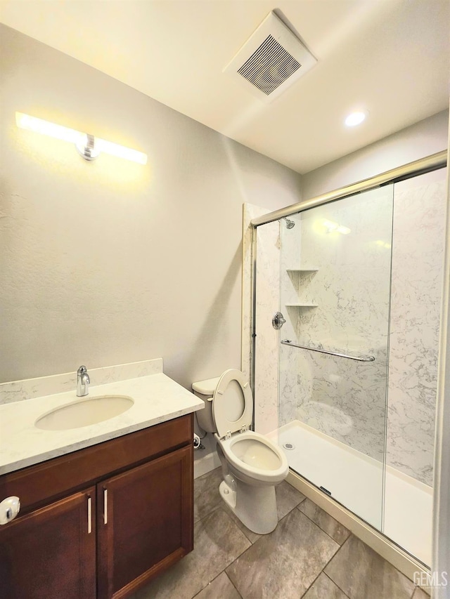 bathroom with vanity, toilet, and an enclosed shower