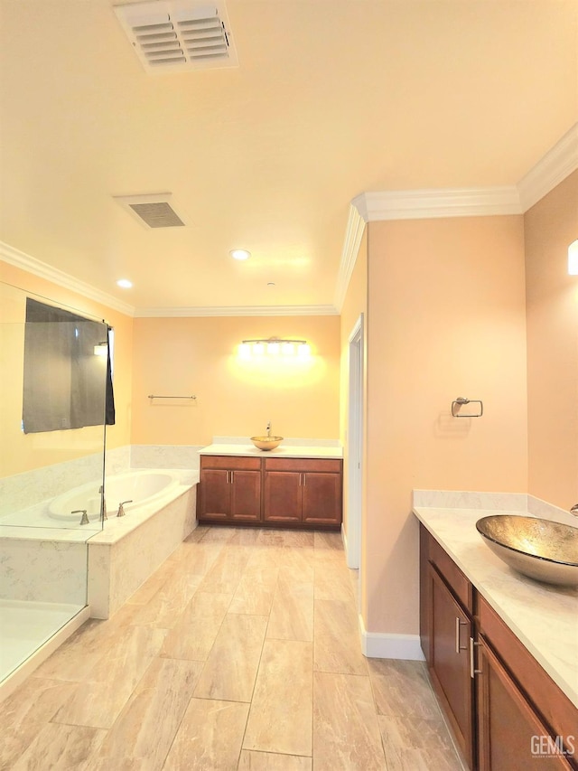 bathroom featuring a relaxing tiled tub, vanity, and crown molding