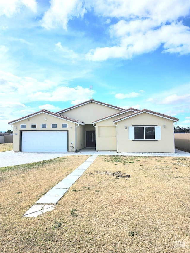 view of front of home with a garage and a front yard