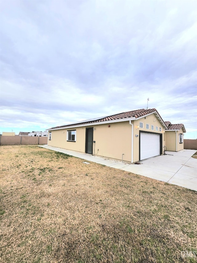 view of front of home with a garage and a front lawn