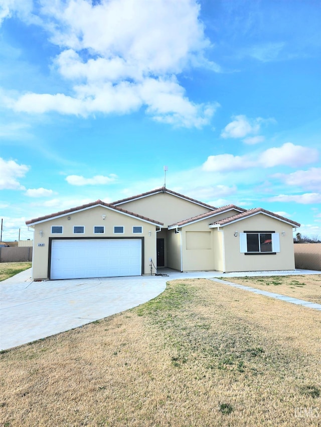 single story home featuring a garage and a front yard