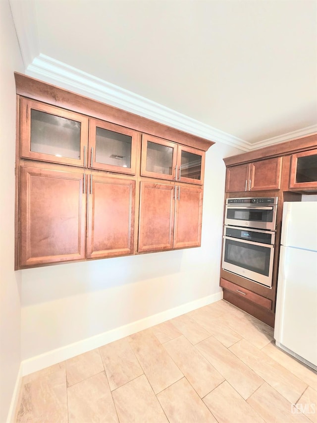 kitchen featuring crown molding, double oven, and white fridge