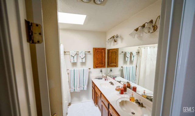 bathroom with vanity and a skylight