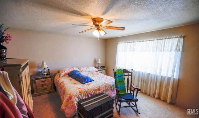 carpeted bedroom with ceiling fan and a textured ceiling