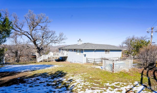 view of snow covered rear of property