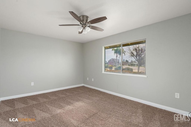 carpeted spare room featuring baseboards and ceiling fan