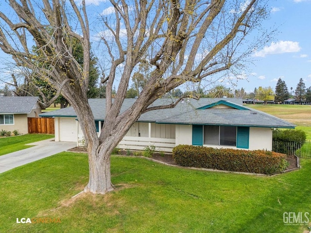 ranch-style home with an attached garage, concrete driveway, a front yard, and fence