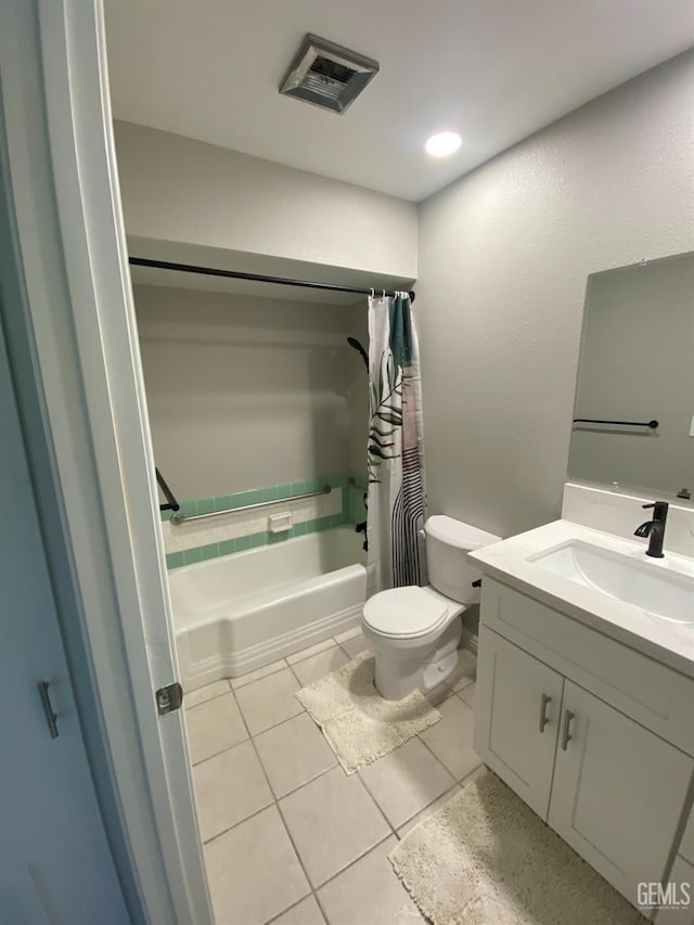 full bath featuring vanity, visible vents, shower / bath combo with shower curtain, tile patterned floors, and toilet