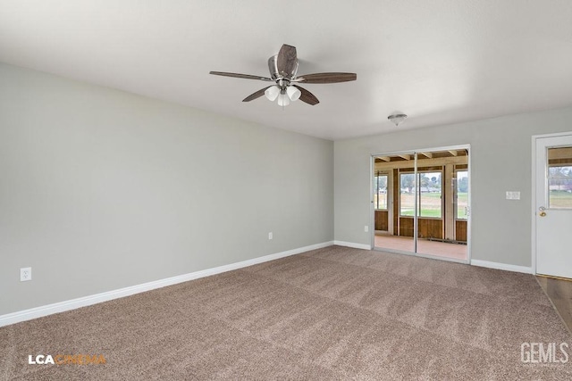 spare room with a ceiling fan, baseboards, and carpet floors