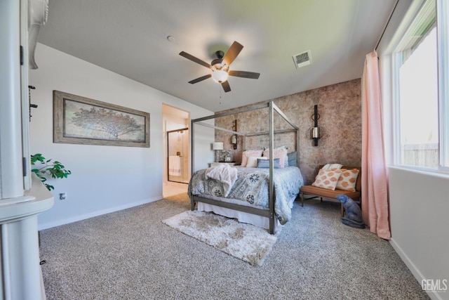 bedroom with carpet floors, visible vents, ceiling fan, ensuite bath, and baseboards