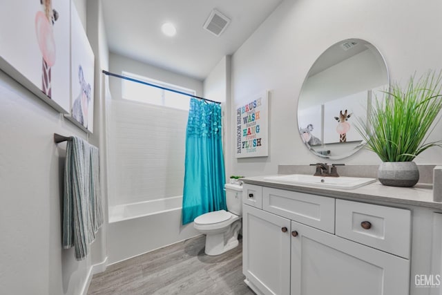 bathroom with toilet, wood finished floors, vanity, visible vents, and shower / bath combination with curtain