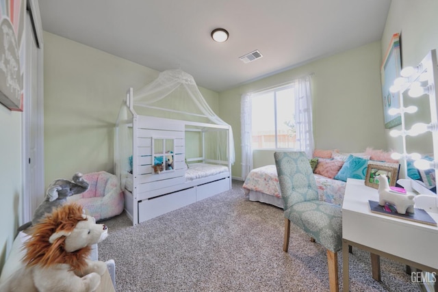 carpeted bedroom featuring visible vents