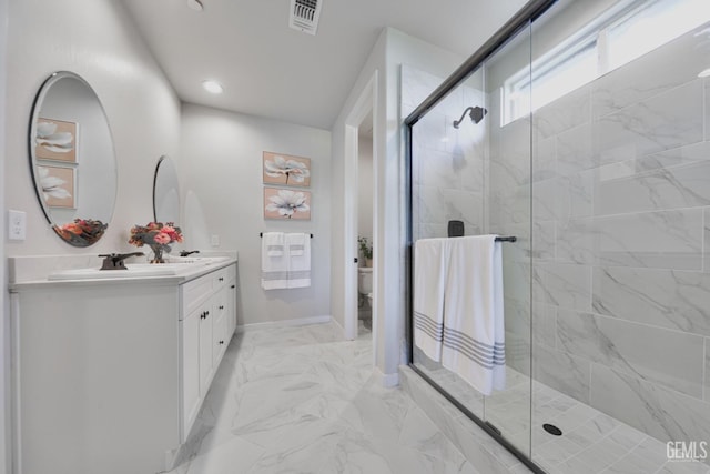 full bath with marble finish floor, a marble finish shower, double vanity, visible vents, and toilet