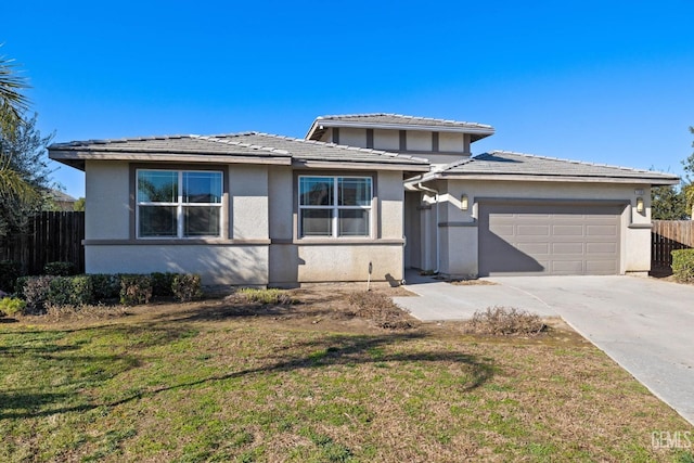 prairie-style home with a garage and a front lawn