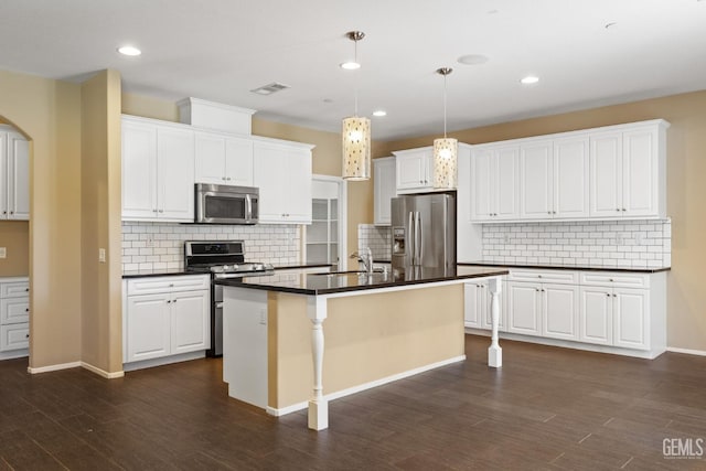 kitchen featuring stainless steel appliances, a kitchen island with sink, and white cabinets