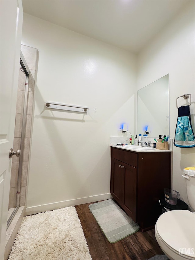 7904 Bristol Spring Ave, Bakersfield, CA 93313 - full bath with wood finished floors, a stall shower, vanity, toilet, and baseboards
