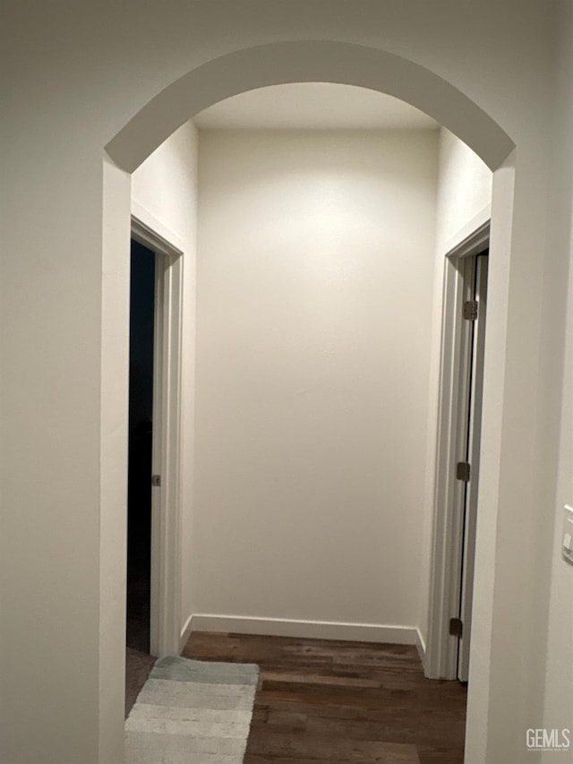 7904 Bristol Spring Ave, Bakersfield, CA 93313 - hallway with dark wood finished floors, arched walkways, and baseboards