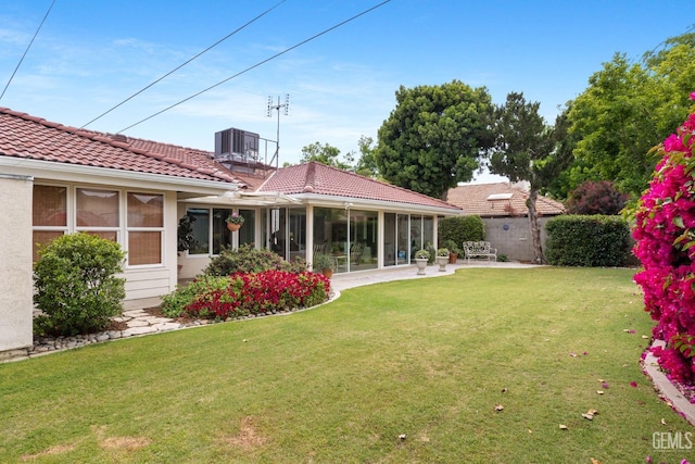 view of yard with a patio, central AC, fence, and a sunroom