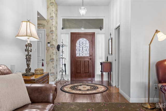 entrance foyer with baseboards and hardwood / wood-style floors