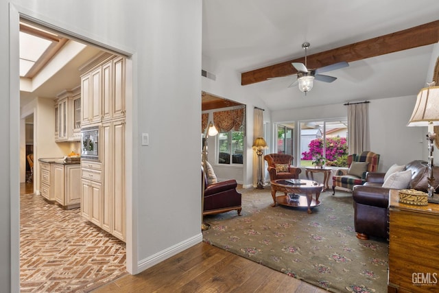 living room with baseboards, ceiling fan, beamed ceiling, and visible vents