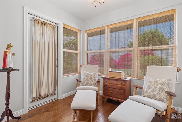 sitting room featuring baseboards and hardwood / wood-style flooring