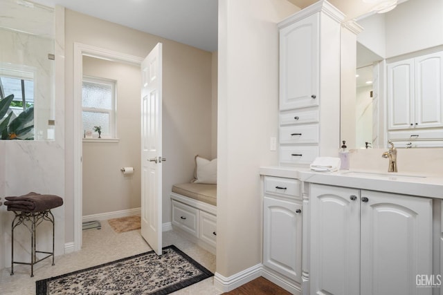 bathroom with vanity and baseboards