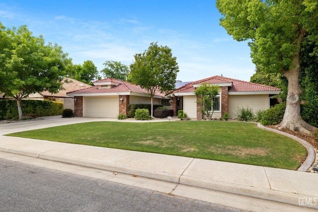 ranch-style home featuring a tile roof, brick siding, a front lawn, concrete driveway, and an attached garage