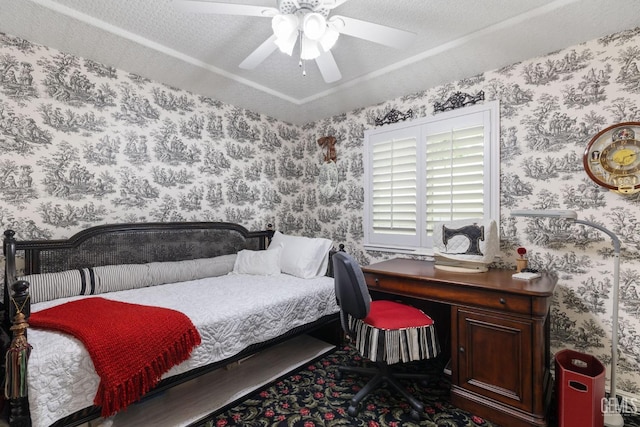 bedroom with a ceiling fan and wallpapered walls