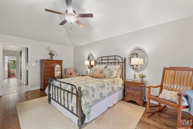 bedroom with a ceiling fan, baseboards, lofted ceiling, and hardwood / wood-style floors