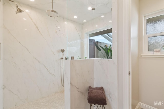 full bathroom with plenty of natural light and a marble finish shower