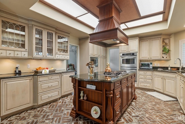 kitchen with a sink, brick floor, open shelves, and cream cabinets