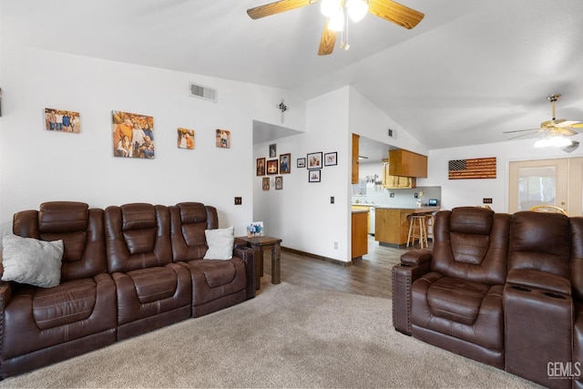 carpeted living room with lofted ceiling, ceiling fan, visible vents, and baseboards