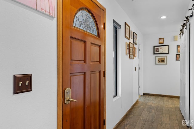 corridor featuring a barn door, baseboards, dark wood-type flooring, and recessed lighting