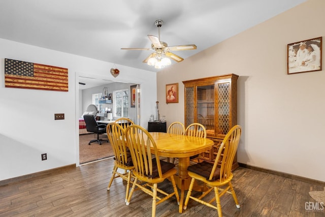 dining area featuring a ceiling fan, baseboards, and wood finished floors