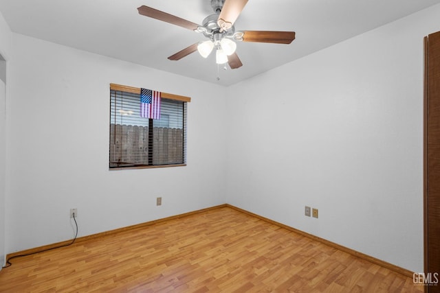 empty room with baseboards, a ceiling fan, and light wood-style floors