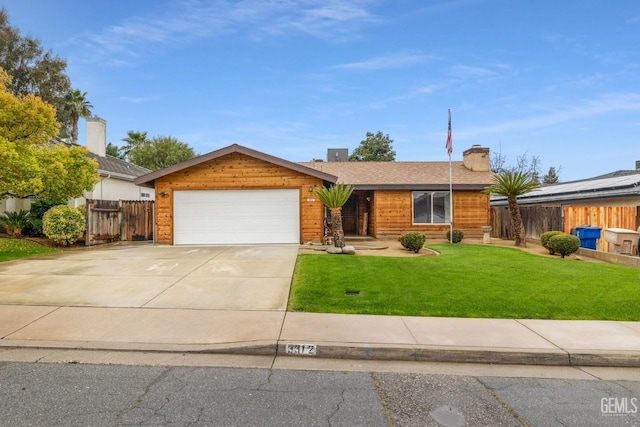 ranch-style home featuring a chimney, concrete driveway, an attached garage, a front yard, and fence