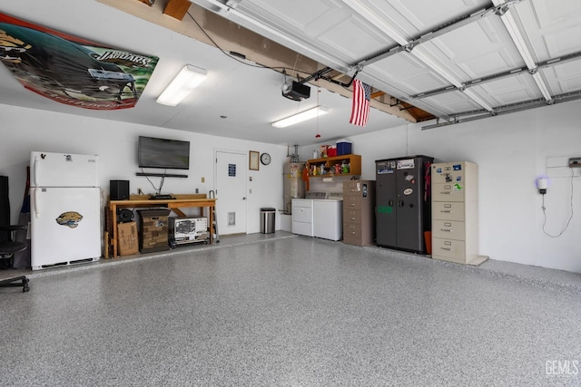 garage featuring a garage door opener, freestanding refrigerator, strapped water heater, and independent washer and dryer