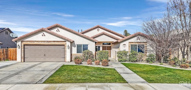 view of front of house featuring a garage and a front lawn