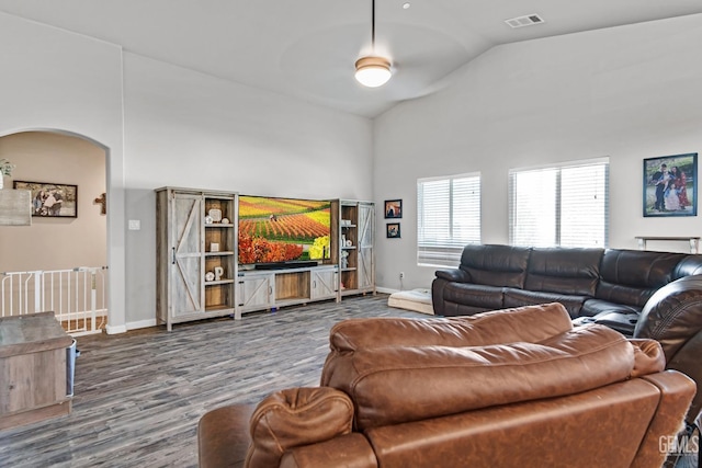 living room featuring vaulted ceiling and wood-type flooring