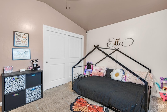 bedroom featuring carpet flooring, vaulted ceiling, and a closet