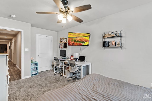 carpeted office space with ceiling fan and lofted ceiling