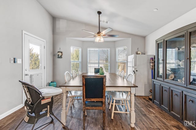 dining room featuring vaulted ceiling, dark hardwood / wood-style floors, and ceiling fan