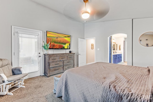 carpeted bedroom featuring sink, ensuite bath, and ceiling fan