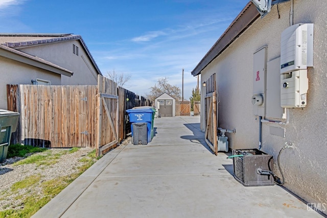 view of property exterior with a patio and a storage unit